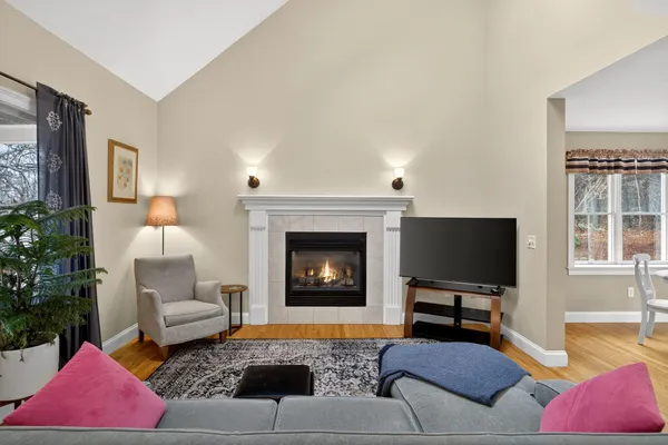 a living room with furniture a flat screen tv and a window