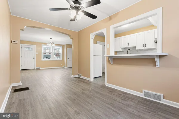 a view of a kitchen with a sink and dishwasher with wooden floor