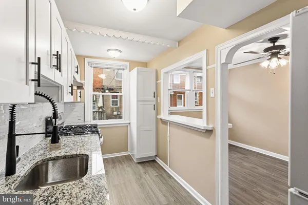 a kitchen with a refrigerator sink and cabinets
