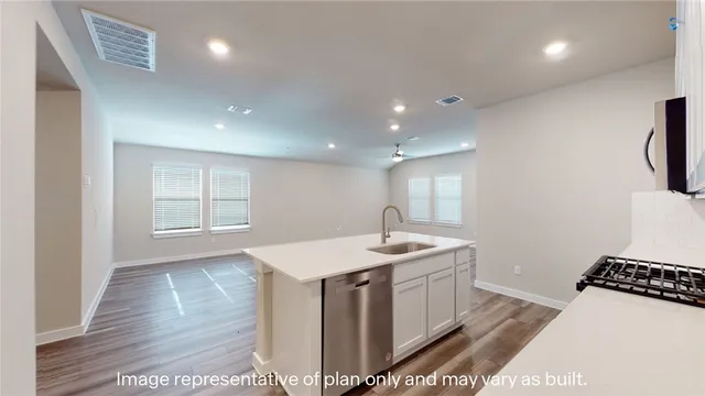 a kitchen with a sink and a stove top oven
