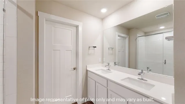a bathroom with a double vanity sink and a mirror