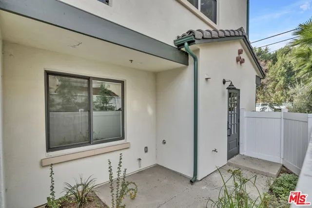 a view of a white building with many windows