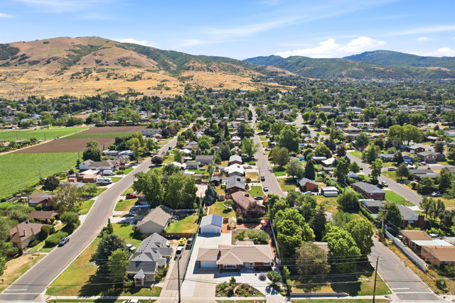1180 North 400 East Bountiful, UT 84010 - Photo 48 of 50 Aerial perspective showcasing a residential neighborhood with established homes, mature trees, and mountainous terrain in the background