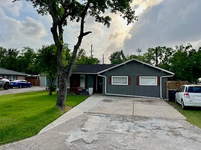 a front view of house with yard and trees