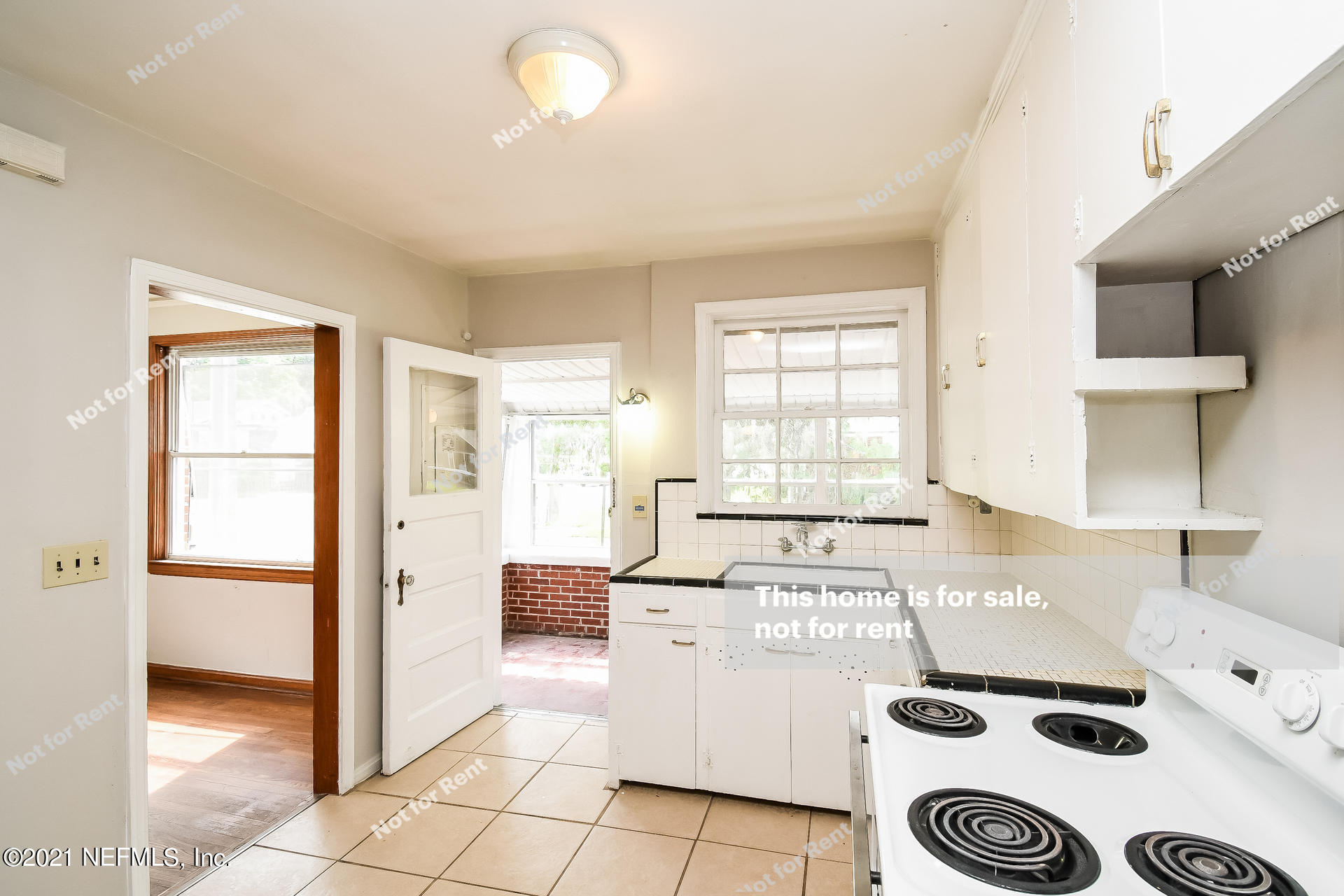 4659 Post Street Jacksonville, FL 32205 - Photo 9 of 25 a kitchen with a stove a sink and a refrigerator
