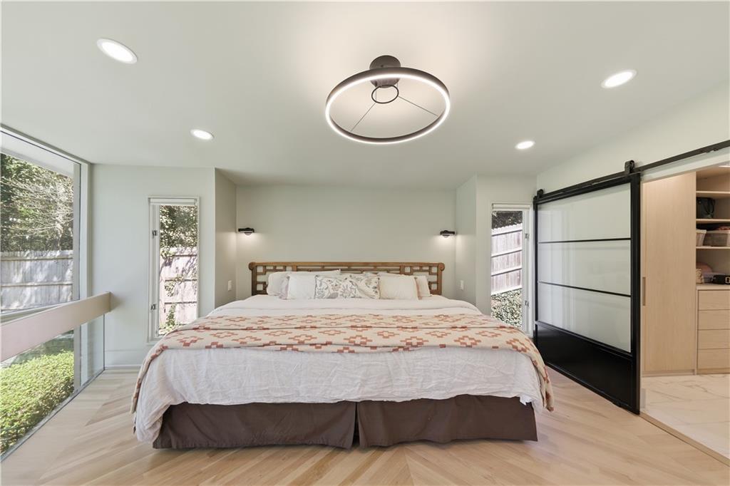 505 Hollydale Court Northwest Atlanta, GA 30342 - Photo 41 of 117 a bedroom with a large bed and a chandelier