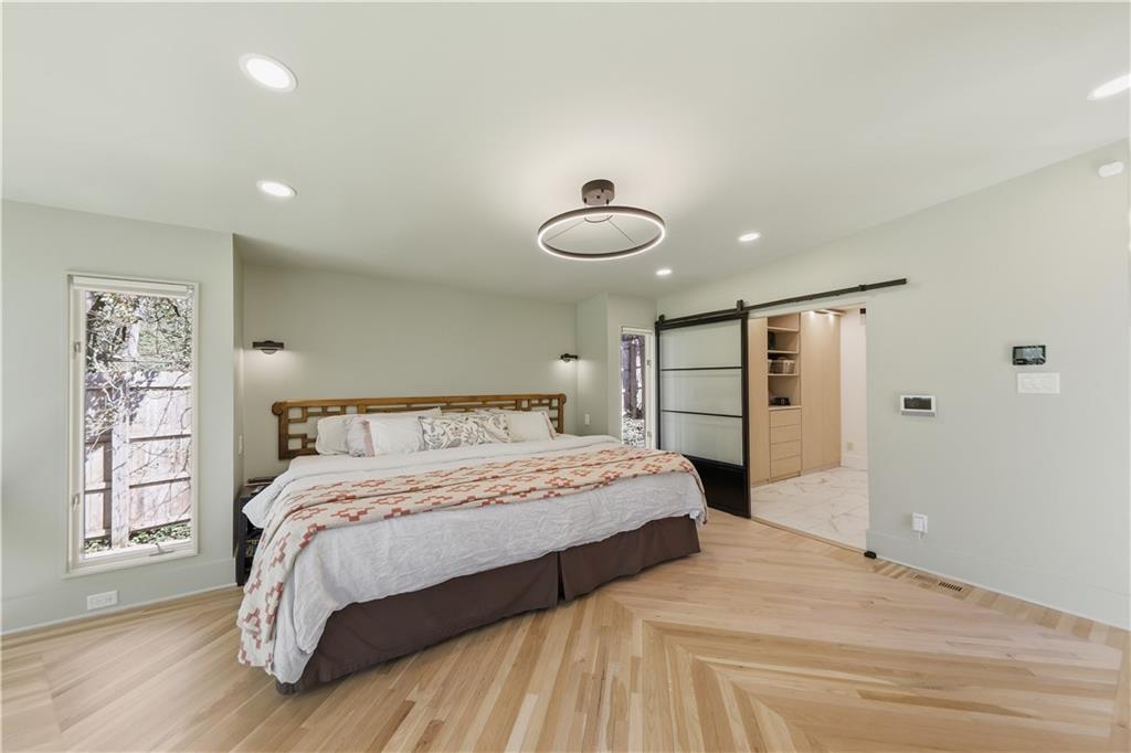 505 Hollydale Court Northwest Atlanta, GA 30342 - Photo 42 of 117 a bedroom with a large bed and a chandelier