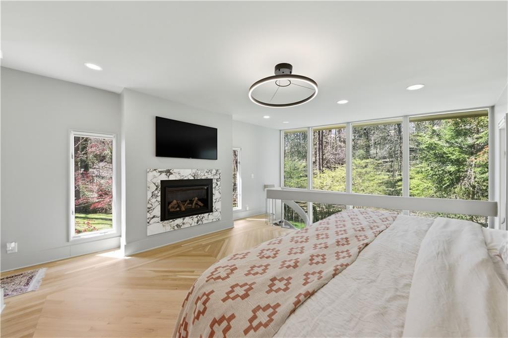 505 Hollydale Court Northwest Atlanta, GA 30342 - Photo 46 of 117 a view of a bedroom with a bed and a fireplace