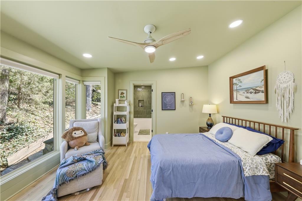 505 Hollydale Court Northwest Atlanta, GA 30342 - Photo 55 of 117 a bedroom with a bed and glass walk in closet