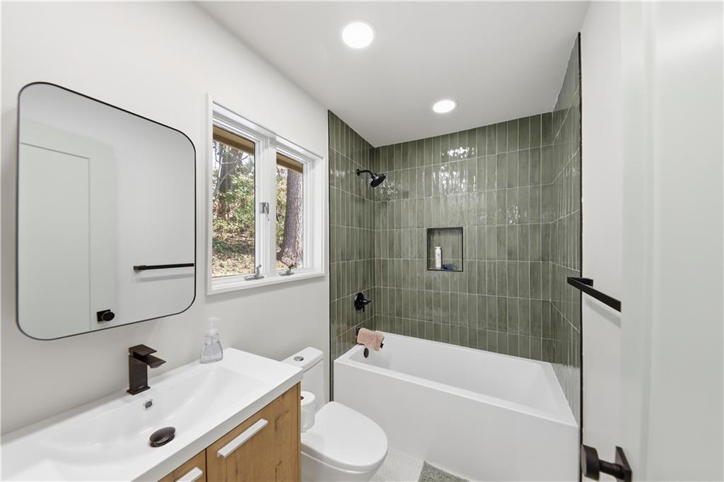 505 Hollydale Court Northwest Atlanta, GA 30342 - Photo 58 of 117 a bathroom with a tub sink toilet and a mirror