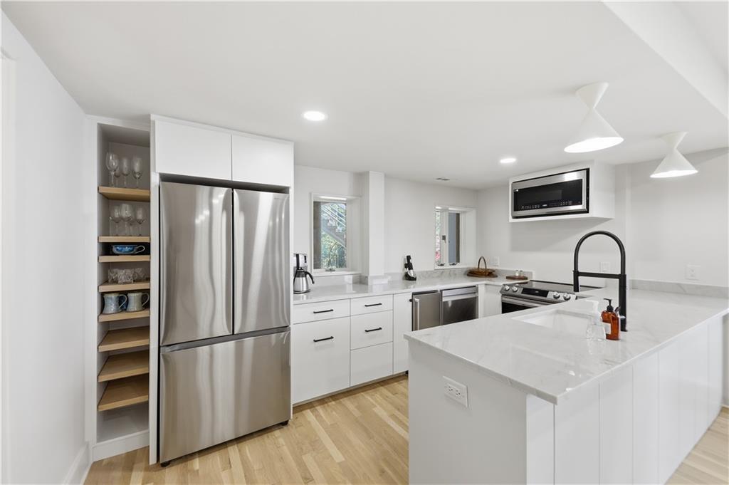 505 Hollydale Court Northwest Atlanta, GA 30342 - Photo 71 of 117 a kitchen with stainless steel appliances a refrigerator sink and cabinets