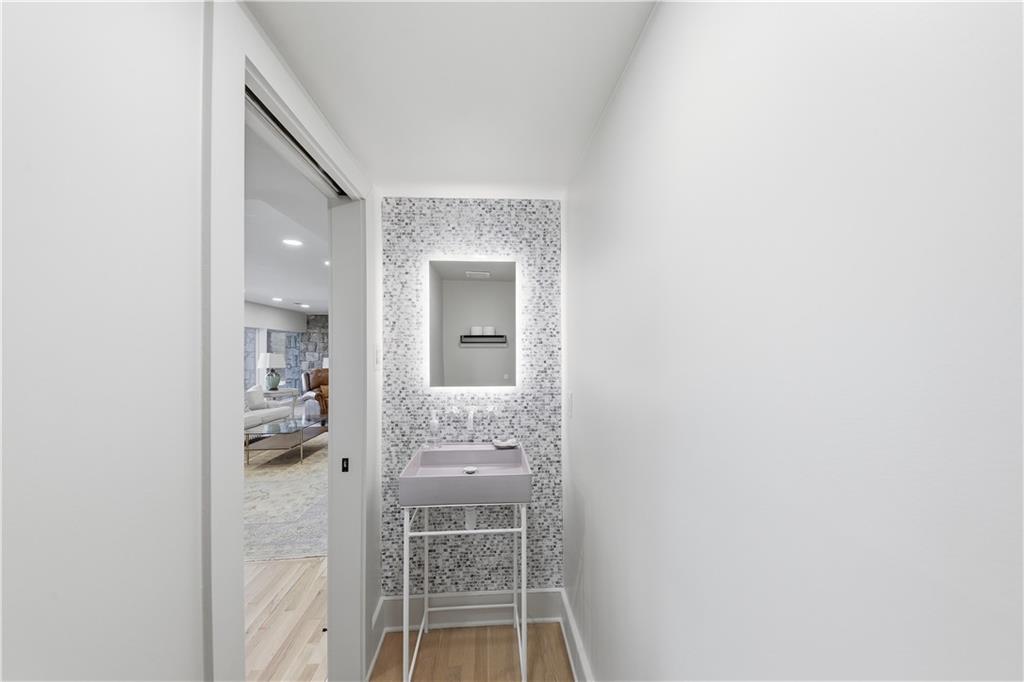 505 Hollydale Court Northwest Atlanta, GA 30342 - Photo 73 of 117 a bathroom with a glass door shower and a sink