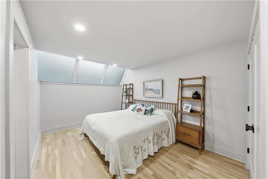 505 Hollydale Court Northwest Atlanta, GA 30342 - Photo 76 of 117 a bedroom with a bed and a painting on the wall