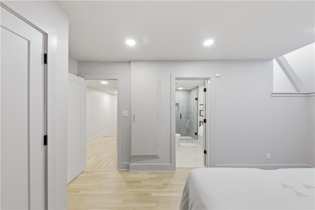 505 Hollydale Court Northwest Atlanta, GA 30342 - Photo 77 of 117 a spacious bedroom with a bed and a shower