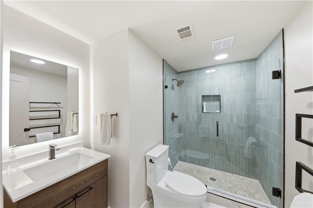 505 Hollydale Court Northwest Atlanta, GA 30342 - Photo 79 of 117 a bathroom with a sink a toilet and shower