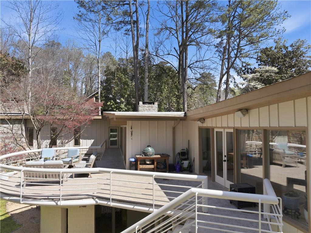 505 Hollydale Court Northwest Atlanta, GA 30342 - Photo 98 of 117 a view of a patio with couches table and chairs with wooden fence and plants