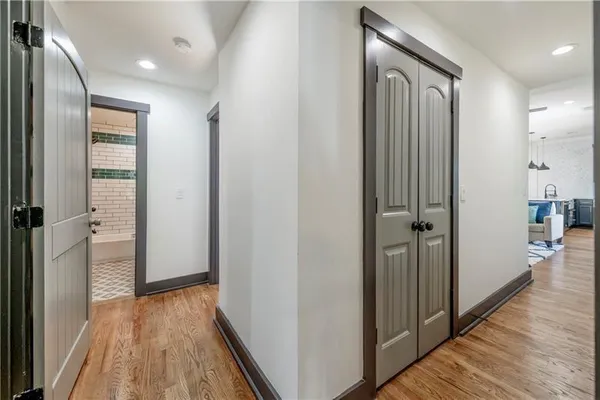 a view of a hallway with wooden floor and staircase