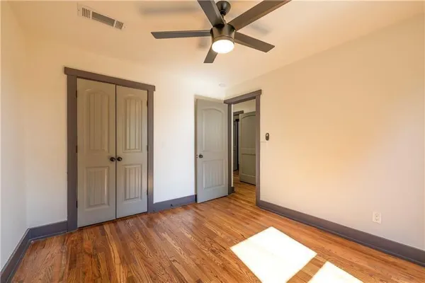 a view of an empty room and wooden floor