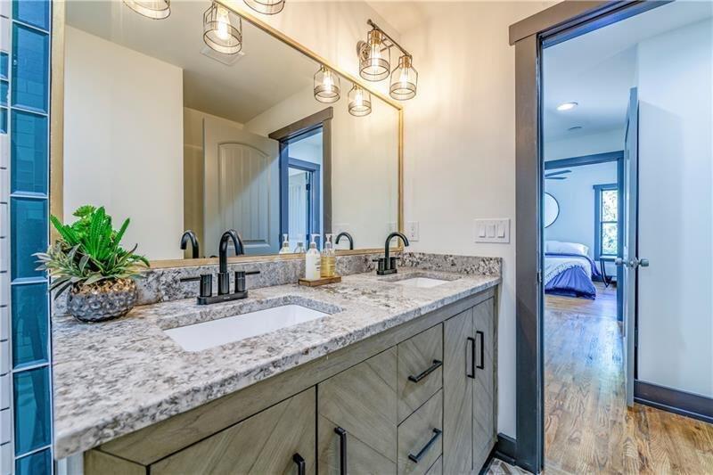 767 Terry Street Southeast, Unit B Atlanta, GA 30315 - Photo 18 of 37 a bathroom with a granite countertop sink a mirror and a potted plant
