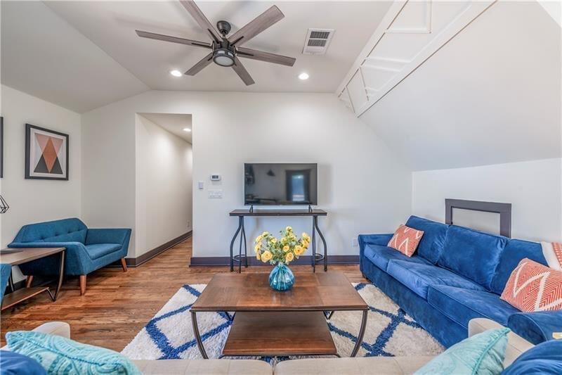 767 Terry Street Southeast, Unit B Atlanta, GA 30315 - Photo 24 of 37 a living room with furniture a rug and a chandelier
