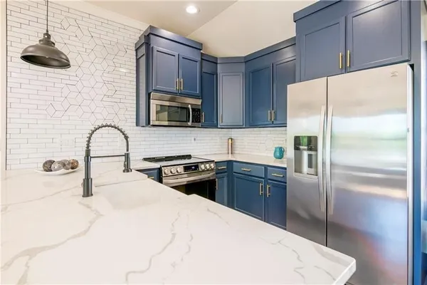 a kitchen with a refrigerator sink and microwave