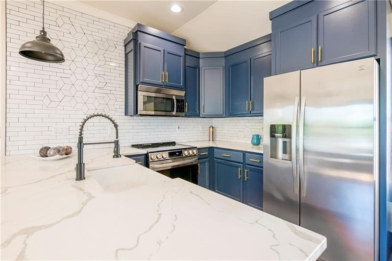767 Terry Street Southeast, Unit B Atlanta, GA 30315 - Photo 30 of 37 a kitchen with a refrigerator sink and microwave