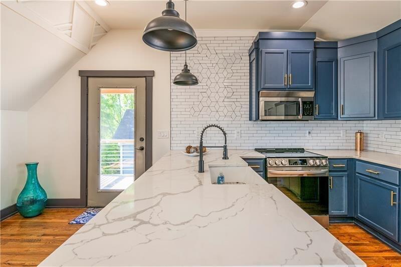 767 Terry Street Southeast, Unit B Atlanta, GA 30315 - Photo 33 of 37 a kitchen with stainless steel appliances granite countertop a stove a sink and a microwave