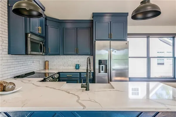 a kitchen with a sink a stove and cabinets
