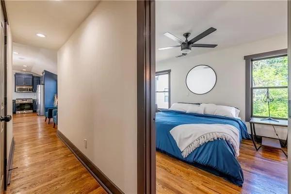 a bedroom with a bed and wooden floor