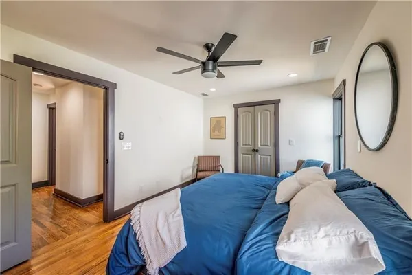 a bed room with a bed mirror and a window