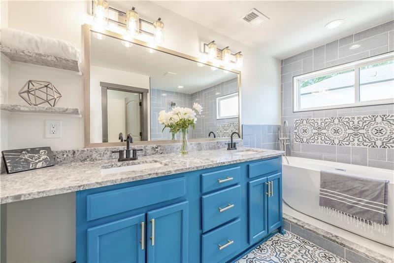 767 Terry Street Southeast, Unit B Atlanta, GA 30315 - Photo 7 of 37 a bathroom with a granite countertop double vanity sink mirror bathtub and window