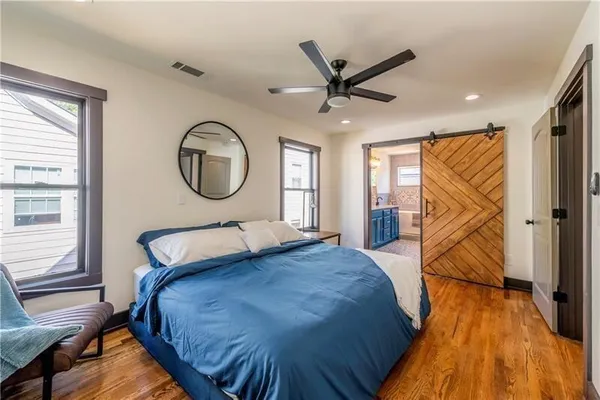 a bedroom with a bed and a chandelier
