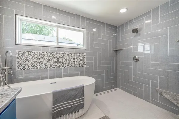 a bathroom with a bathtub and shower