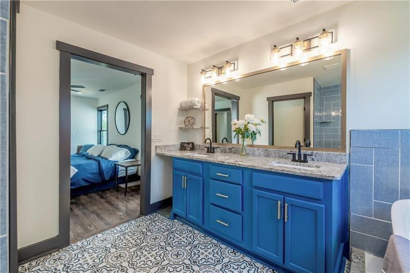 767 Terry Street Southeast, Unit B Atlanta, GA 30315 - Photo 10 of 37 a spacious bathroom with a granite countertop sink and a mirror