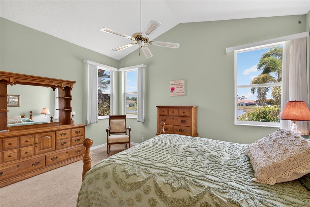4266 Summertree Road Venice, FL 34293 - Photo 19 of 64 a bedroom with a bed and dresser with mirror