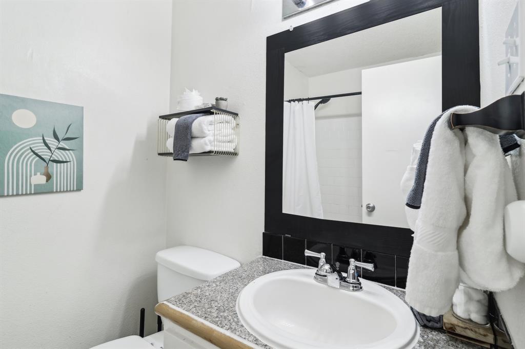 3107 Speedway, Unit 202 Austin, TX 78705 - Photo 10 of 11 a bathroom with a granite countertop sink and a mirror
