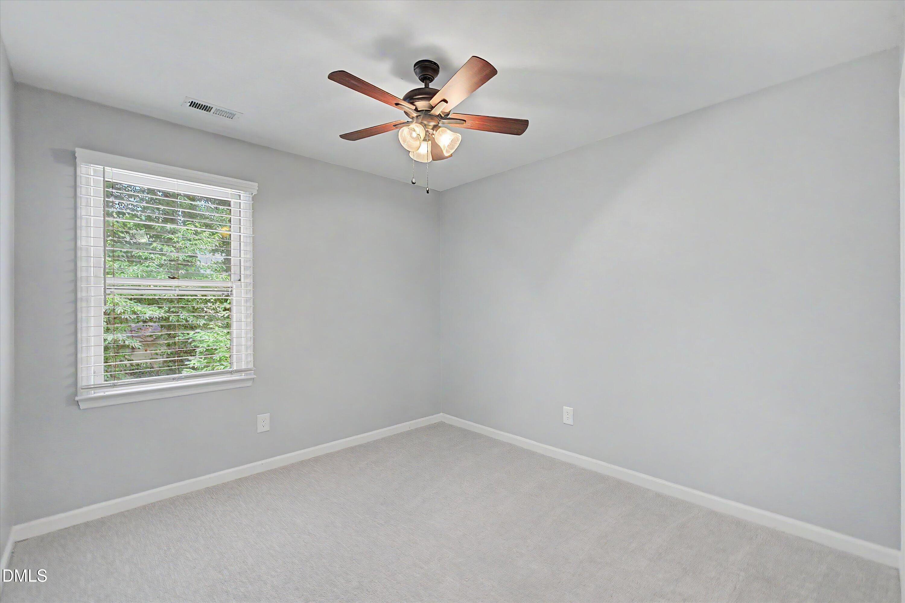 5519 Hamstead Crossing Raleigh, NC 27612 - Photo 25 of 33 an empty room with windows and fan