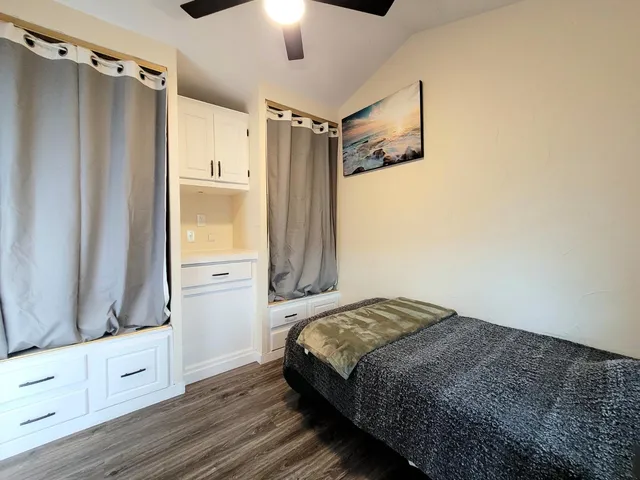 a bedroom with a bed and a dresser