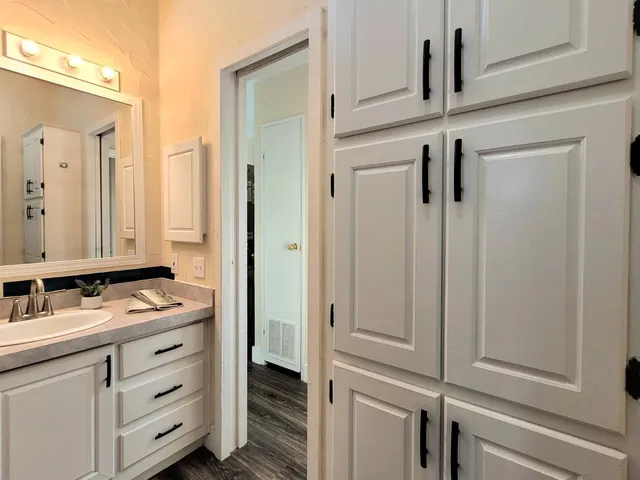 a bathroom with a sink vanity and mirror
