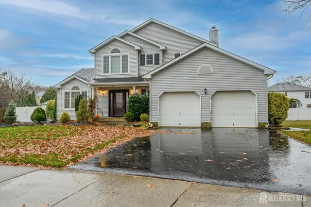 a view of a hallway with wooden floor and a living room