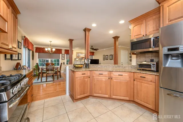 a living room with furniture a chandelier and a dining table