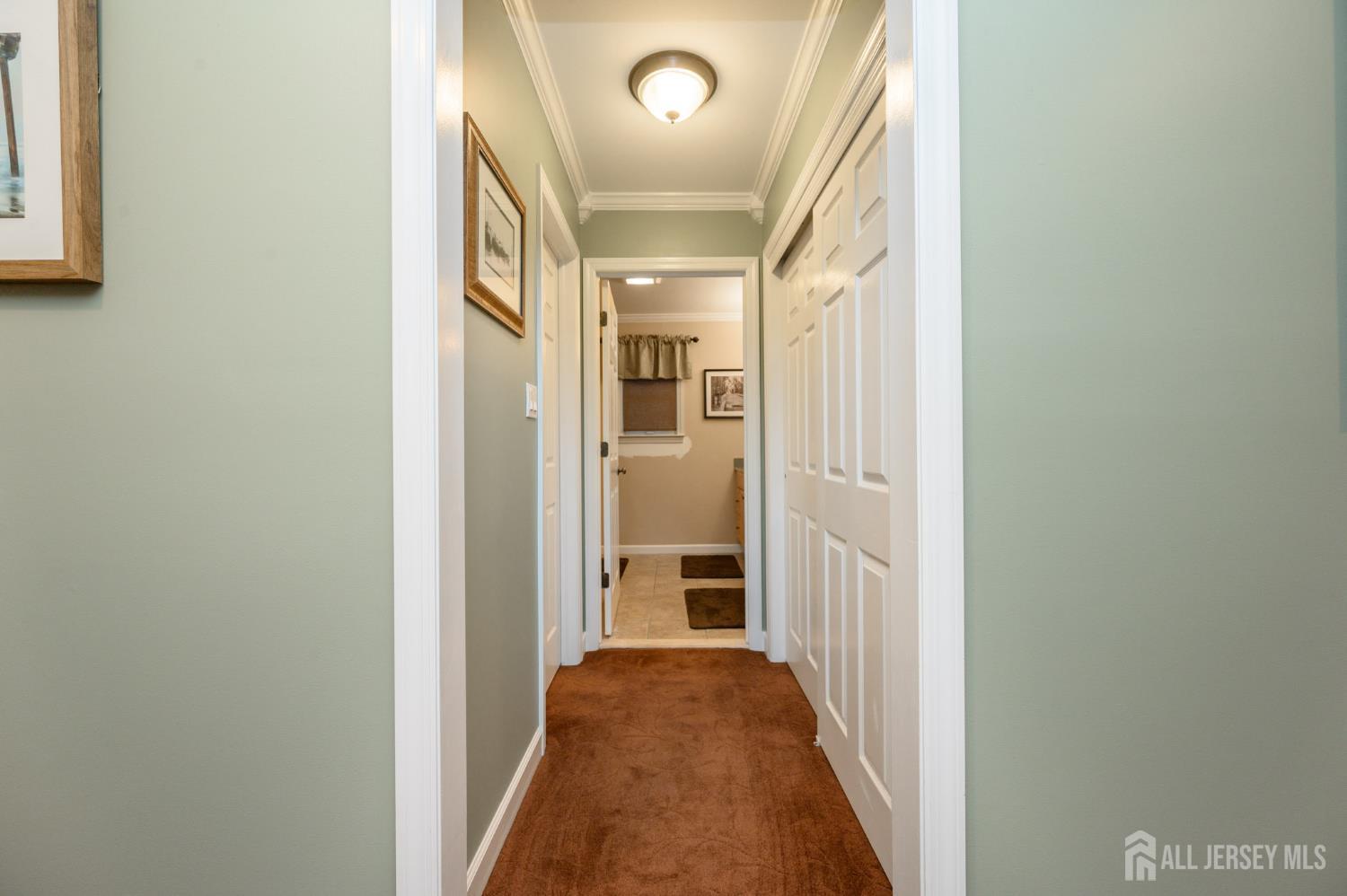 12 Diamond Lane Howell, NJ 07731 - Photo 23 of 47 a view of a hallway with wooden floor and windows