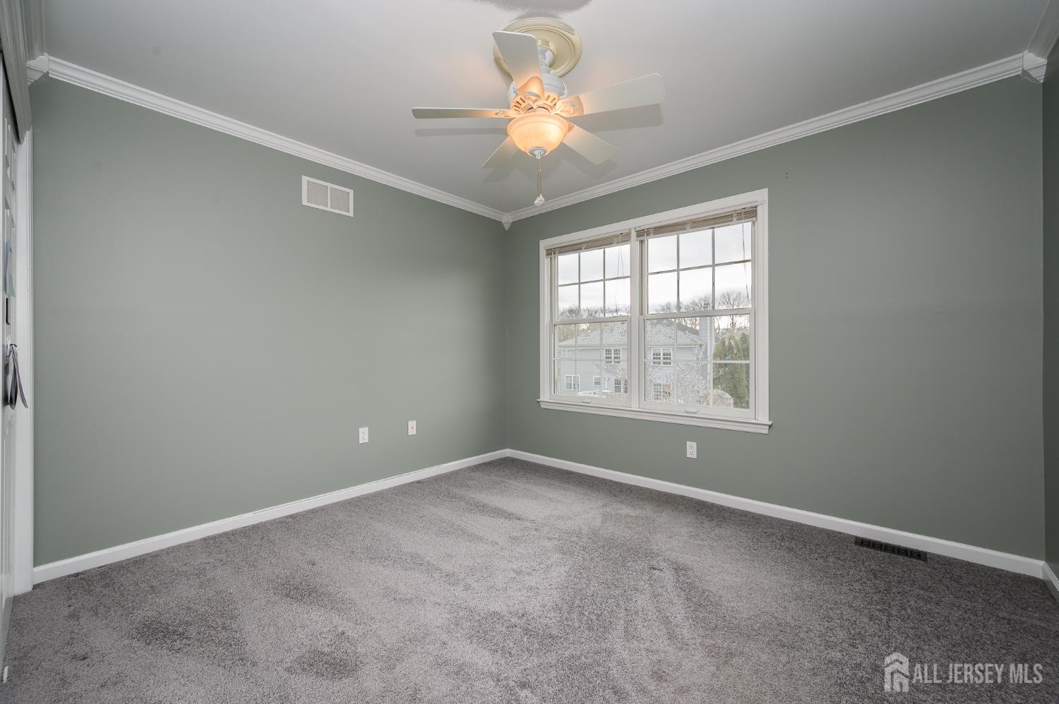 12 Diamond Lane Howell, NJ 07731 - Photo 27 of 47 an empty room with windows and chandelier fan