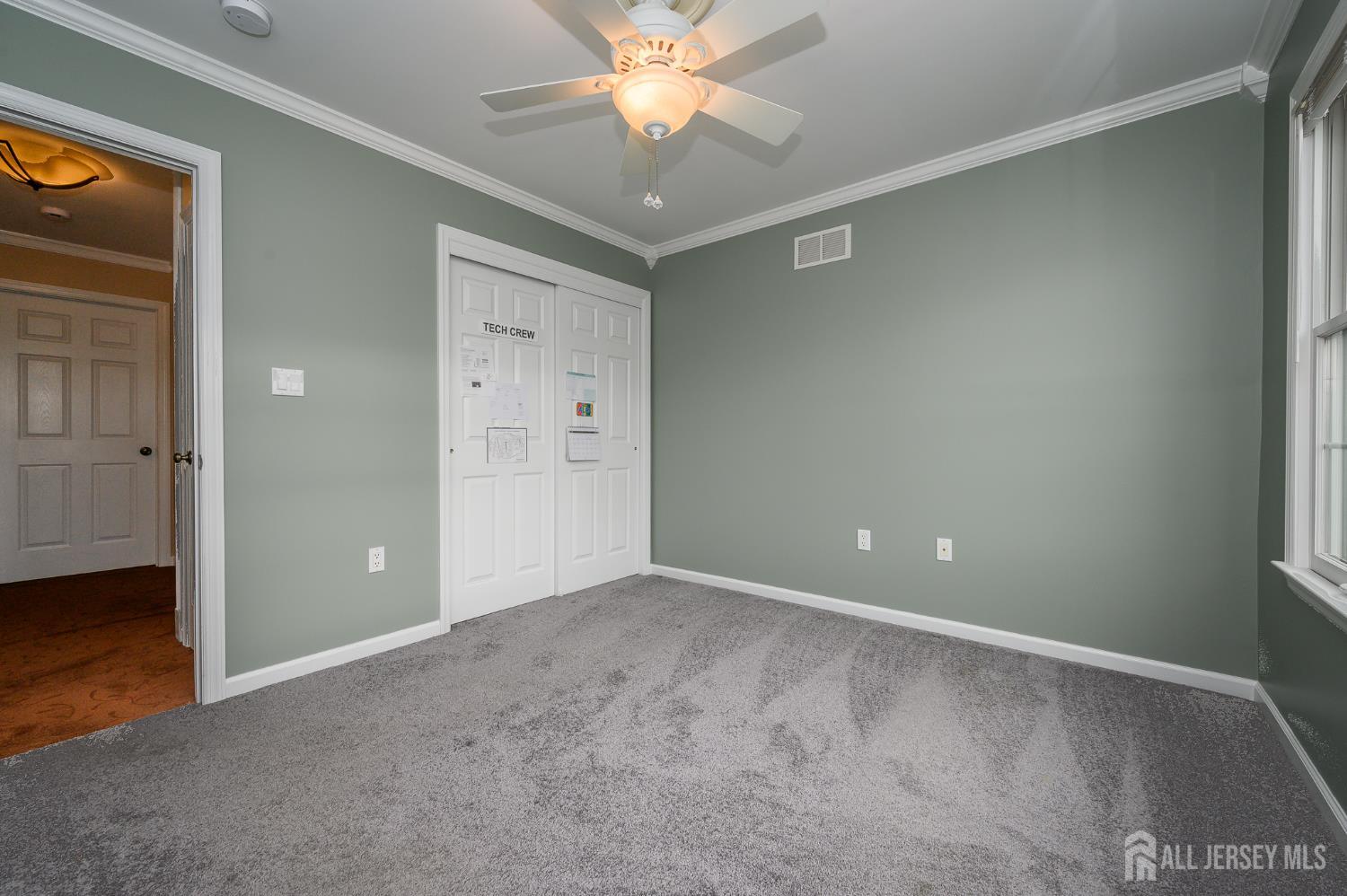 12 Diamond Lane Howell, NJ 07731 - Photo 28 of 47 an empty room with closet and a chandelier fan