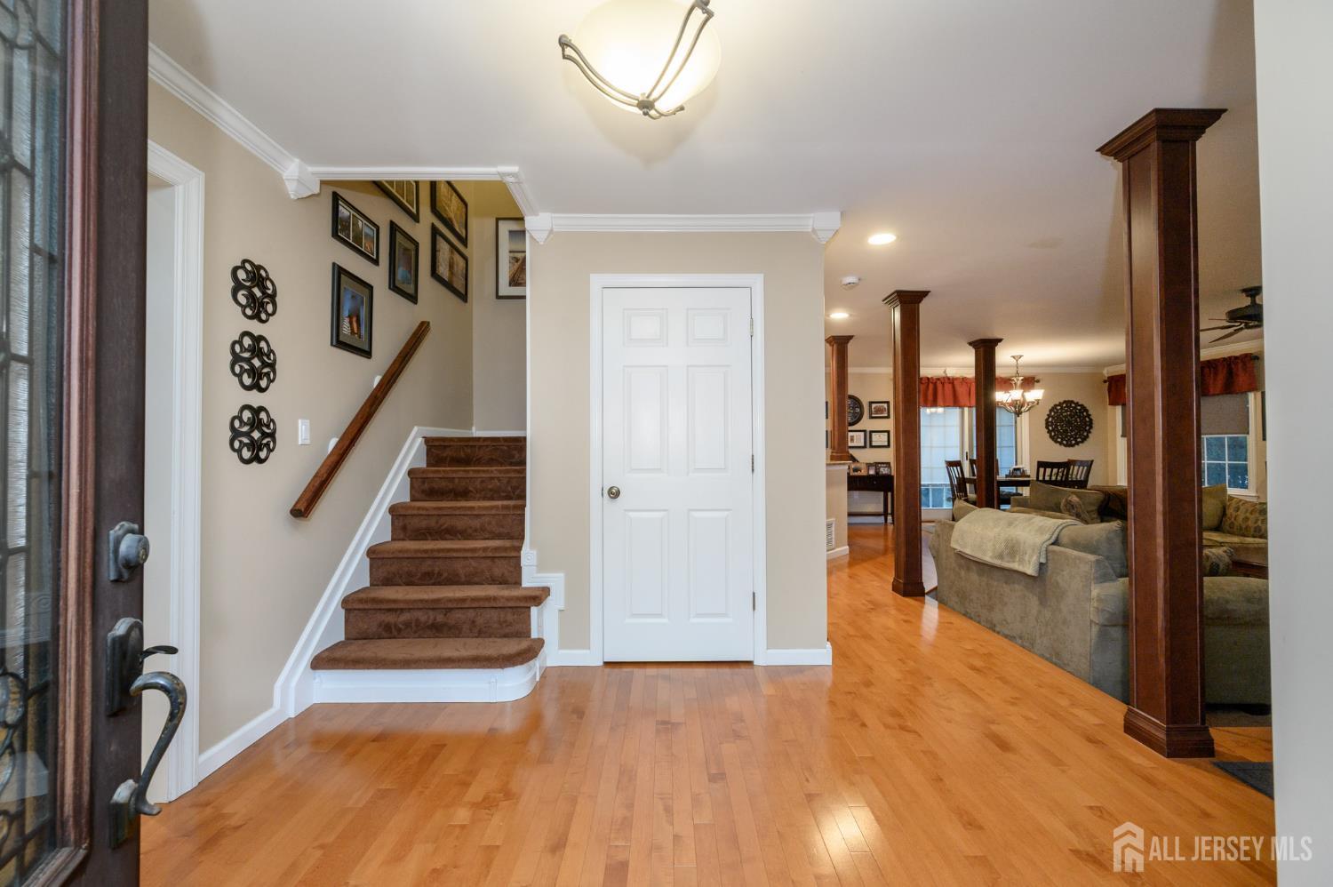 12 Diamond Lane Howell, NJ 07731 - Photo 3 of 47 a view of a hallway with wooden floor and a living room
