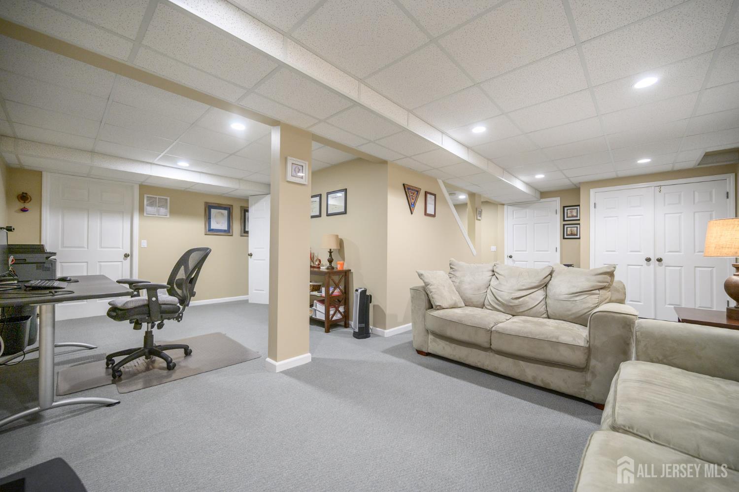 12 Diamond Lane Howell, NJ 07731 - Photo 38 of 47 a living room with furniture a rug and gym equipment