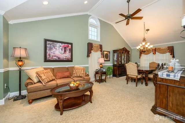 a dining room with furniture and chandelier