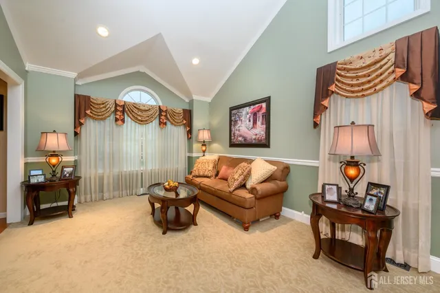 a view of a dining room with furniture and a chandelier