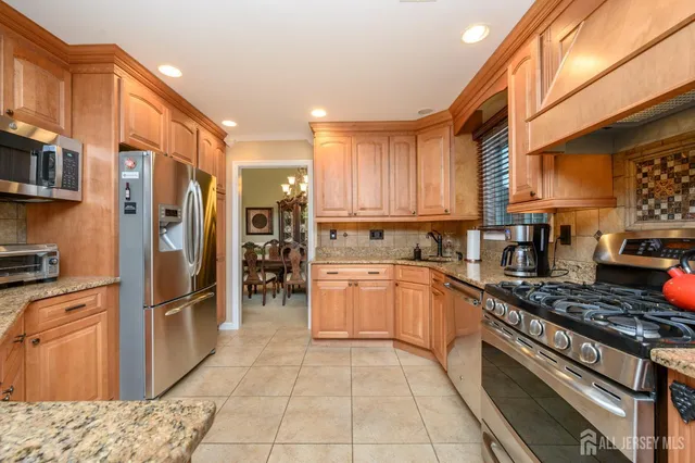 a kitchen with cabinets appliances and a window