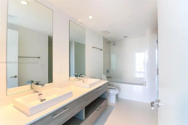 a bathroom with a glass shower door